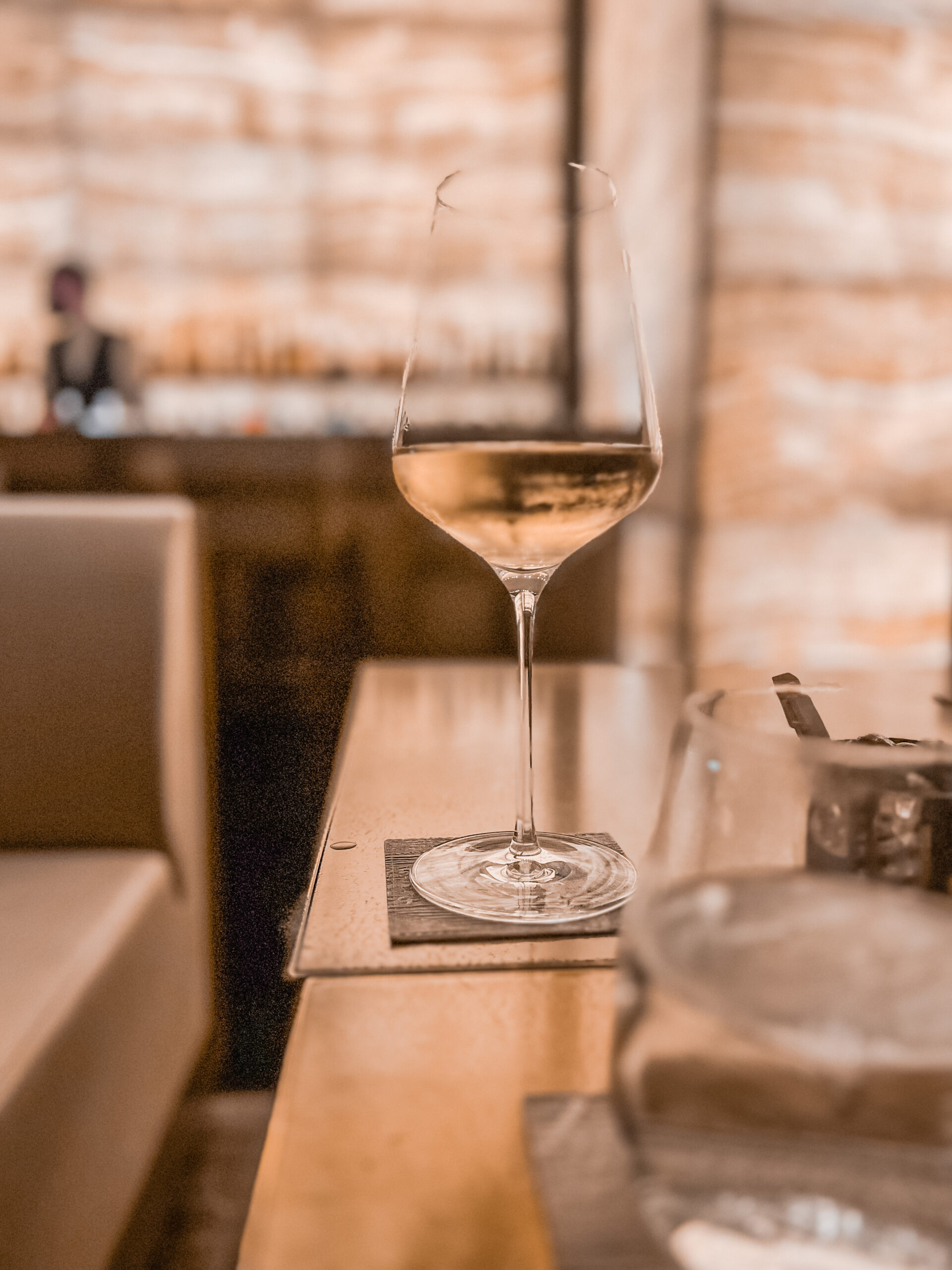 A glass of wine on a bar table in the Armani Hotel