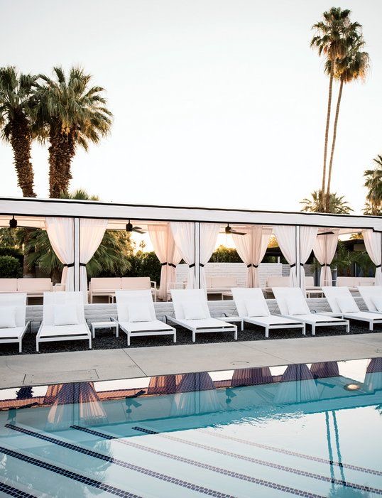 The pool, white loungers and cabanas at L'Horizon hotel in Palm Springs